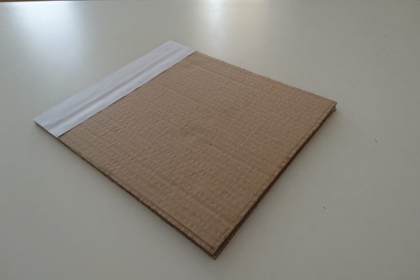 The paper/cardboard mockup of the final brochure cover